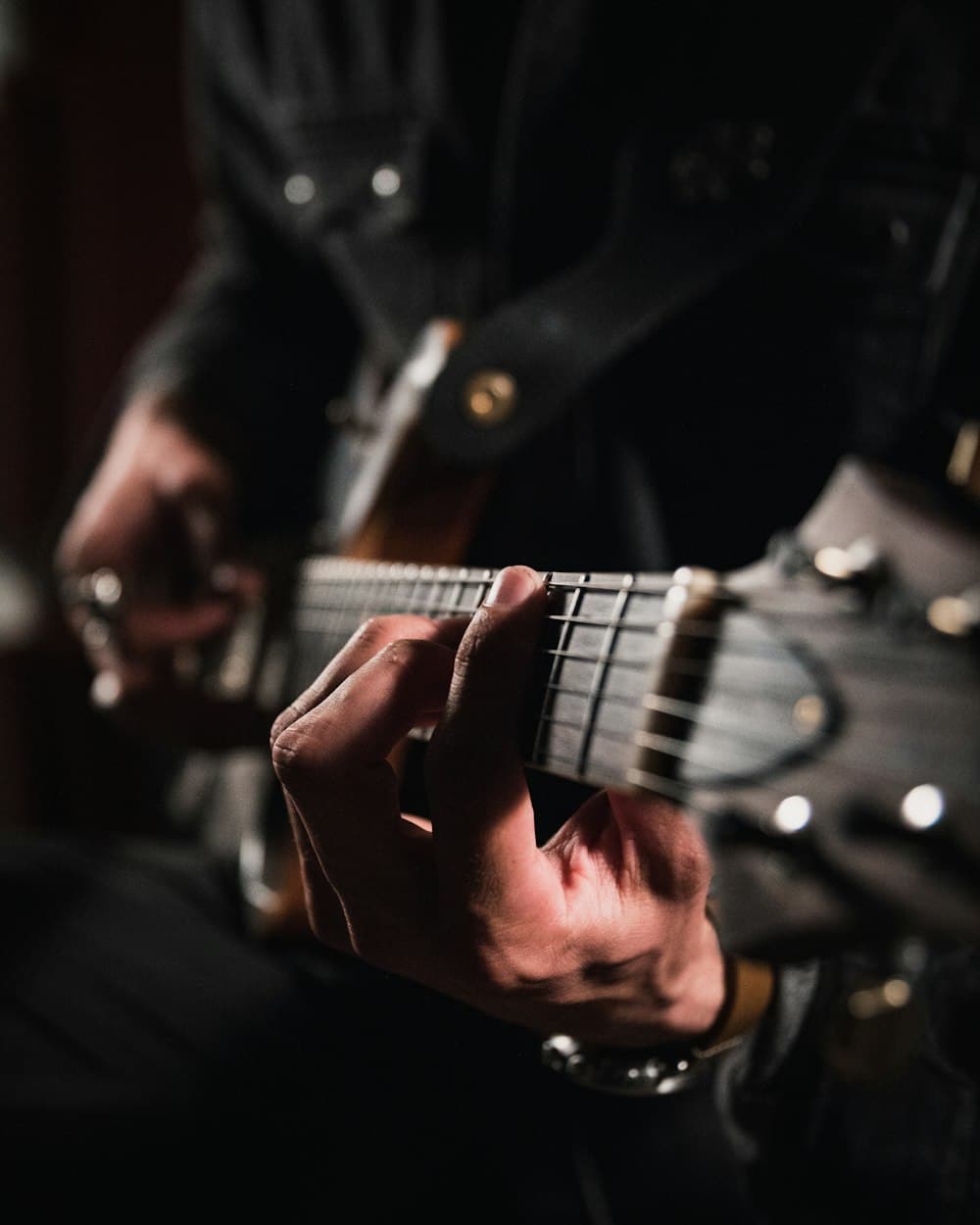 Close-up of hands playing a guitar